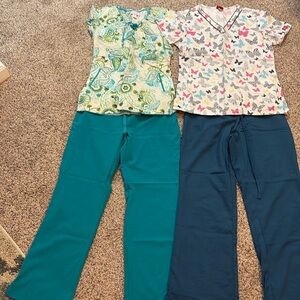 Mixed bundle of scrubs, range in size from extra small to small.